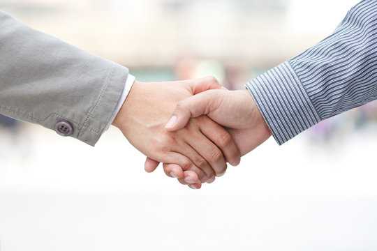 Businessmen shaking hands on white background