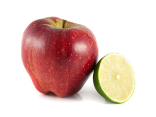 Isolated red apple with sliced lime on a white