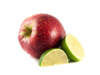 Isolated red apple with sliced lime on a white