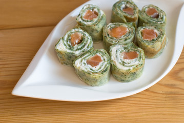 Rolls of pancakes with spinach