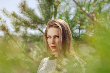 Portrait of beautiful young girl outdoors in spring
