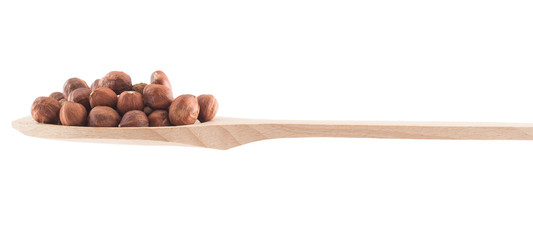 Spoon full of hazelnuts isolated