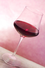 red wine glass over pink background