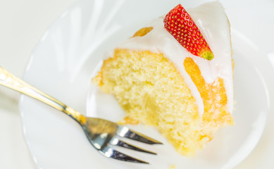 A slice of cheese pound cake coated with sugar glaze