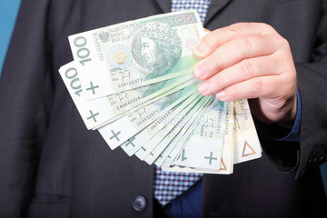 Businessman holding money polish banknote
