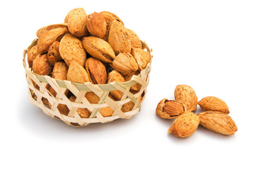 almond nuts in weaven basket on white