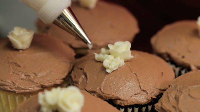 Close up of decorating cupcakes