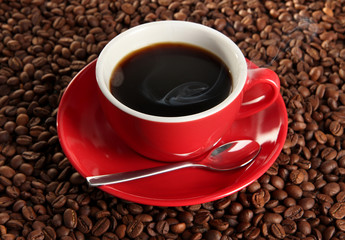 Cup of coffee on coffee beans background