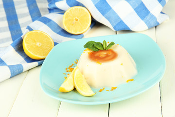 Lemon Panna Cotta with orange zest and caramel sauce,