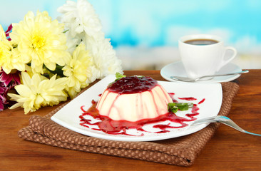 Panna Cotta with raspberry sauce, on bright background