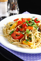 Noodles with vegetables on plate close-up