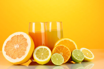 Lots ripe citrus with juices on orange background