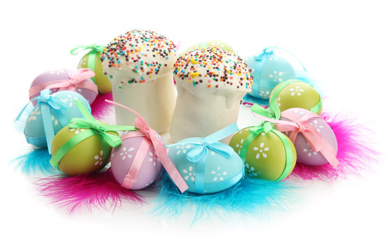 Wreath of bright easter eggs and decorative feathers and cakes,