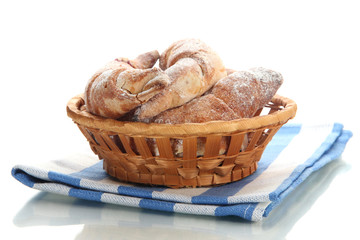 Taste croissants in basket isolated on white.