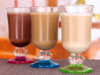 Layered coffee in glass on table on bright background