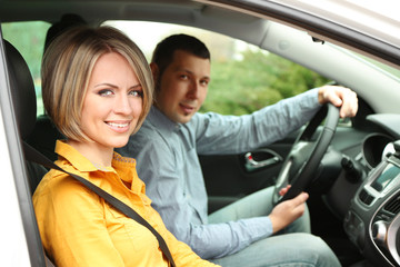 Portrait of young beautiful  couple sitting in the car