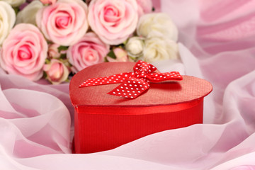 Beautiful gift on flowers background