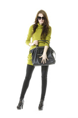 Fashion young woman in sunglasses holding black handbag
