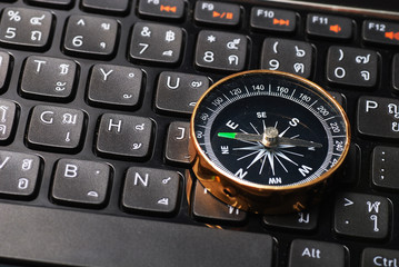 compass on computer keyboard, business decision