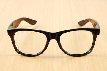 black glasses on wood  background