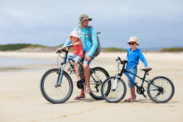 Father and kids riding bikes