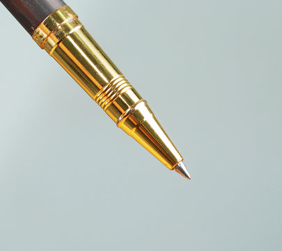 close up of a gold ballpoint pen
