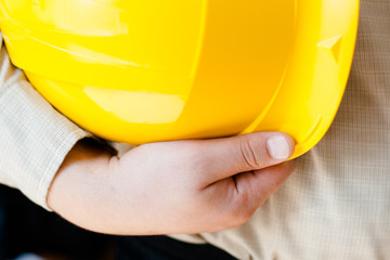 worker with helmet in hand