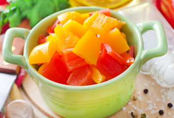 red and yellow peppers on wooden background