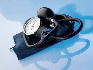 Sphygmomanometer on blue background