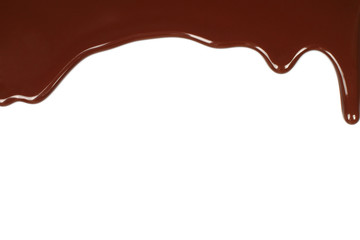 Melted chocolate dripping on white background .