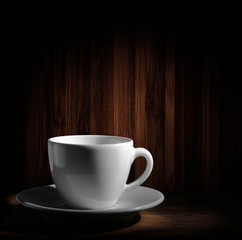 warm cup of coffee on brown background