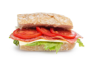 big sandwich with salami cheese tomato and salad leaves