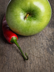 ripe green apple and chili pepper close up