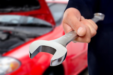 Hand with wrench. Auto mechanic.