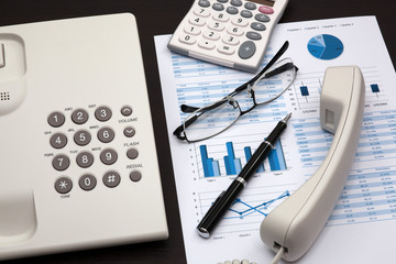 business report with telephone on a table