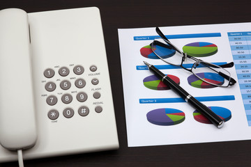 business report with telephone on a table