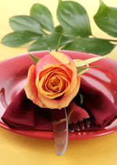 Served plate with napkin and flowers close-up