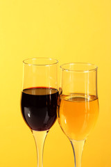 Wine in glasses  on yellow  background