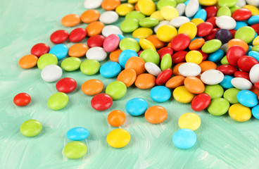 Colorful candies on green background