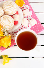 Beautiful composition with cup of tea and marshmallow