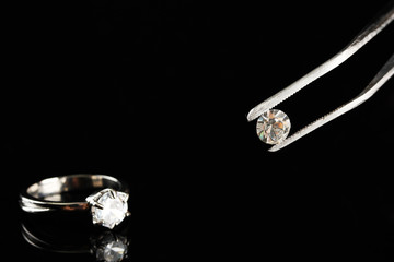 Shining crystal (diamond) in the tweezers and ring,