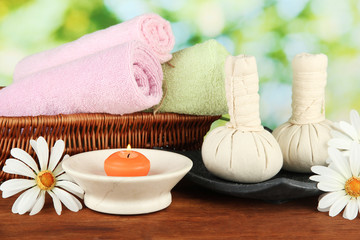 Fototapeta na wymiar Textile massage spa equipment on nature background