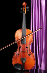 Fototapeta na wymiar Classical violin on curtain background