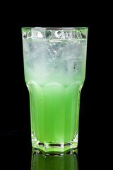 green alcholol cocktail isolated on black