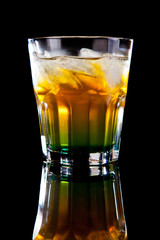 Yellow green alcohol cocktail isolated on black