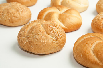 Close up of fresh rolls bread with sesame seeds from the oven