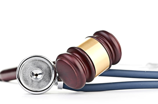 brown gavel and a medical stethoscope