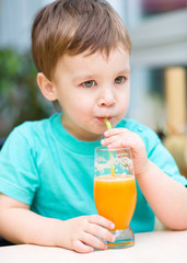 Little boy with glass of orange juice