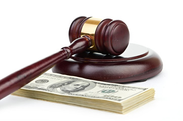 Law gavel on a stack of American money.