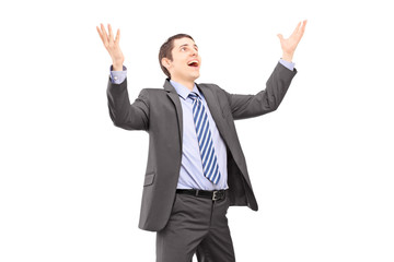 Young businessman with raised hands waiting something to fall